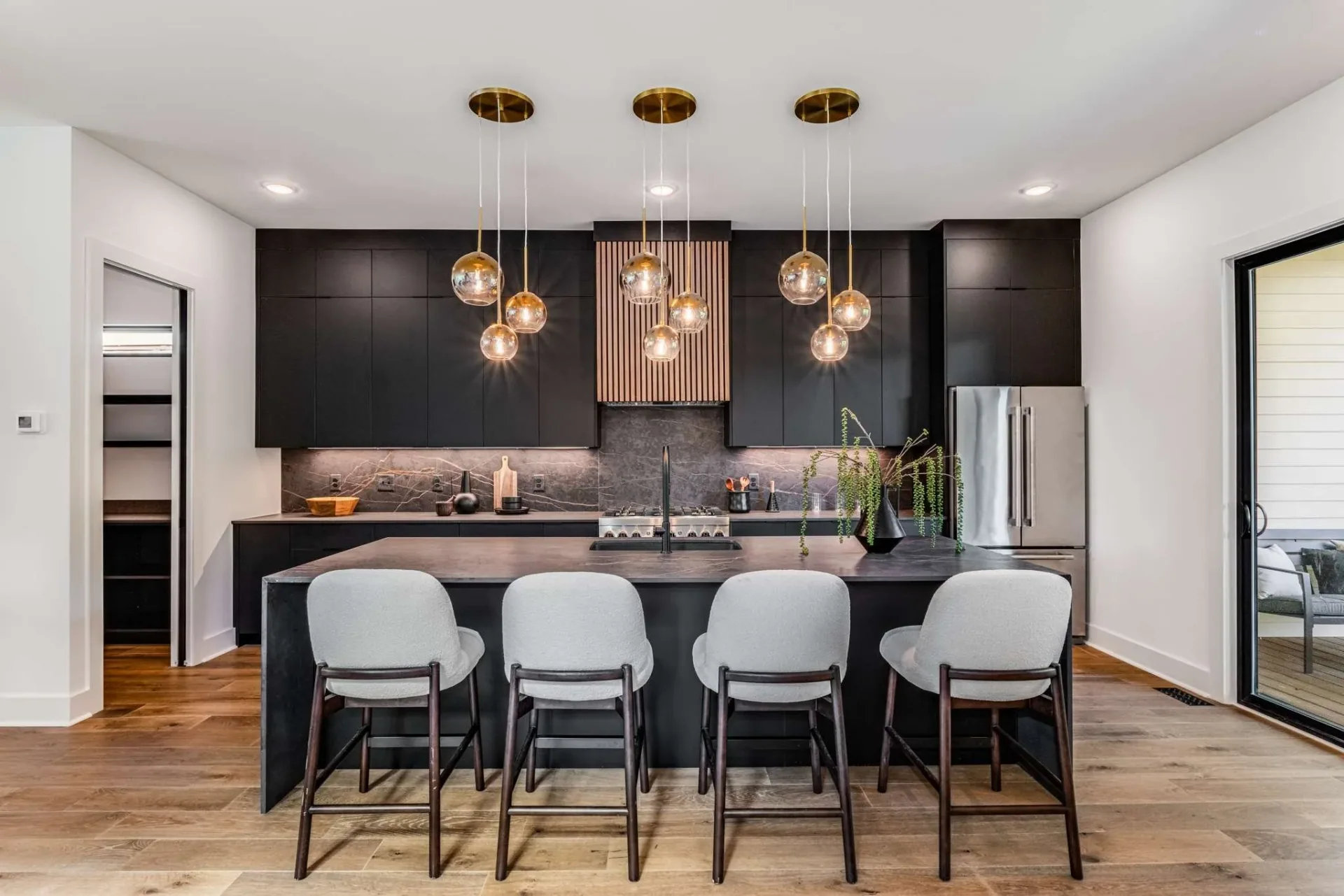 Dark flat-panel cabinetry and a stone island in the Battlefield project