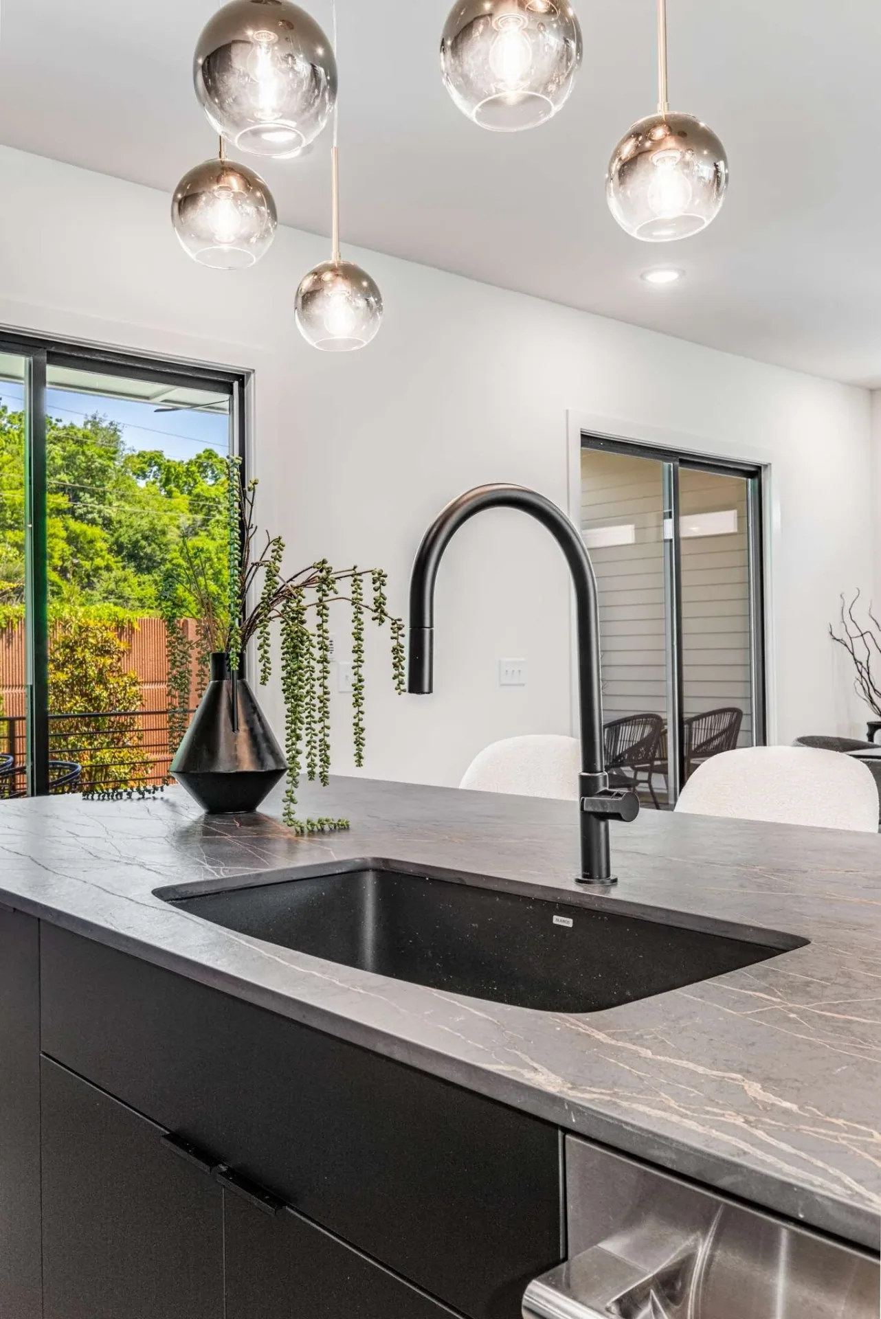 Dark island cabinetry with an integrated sink