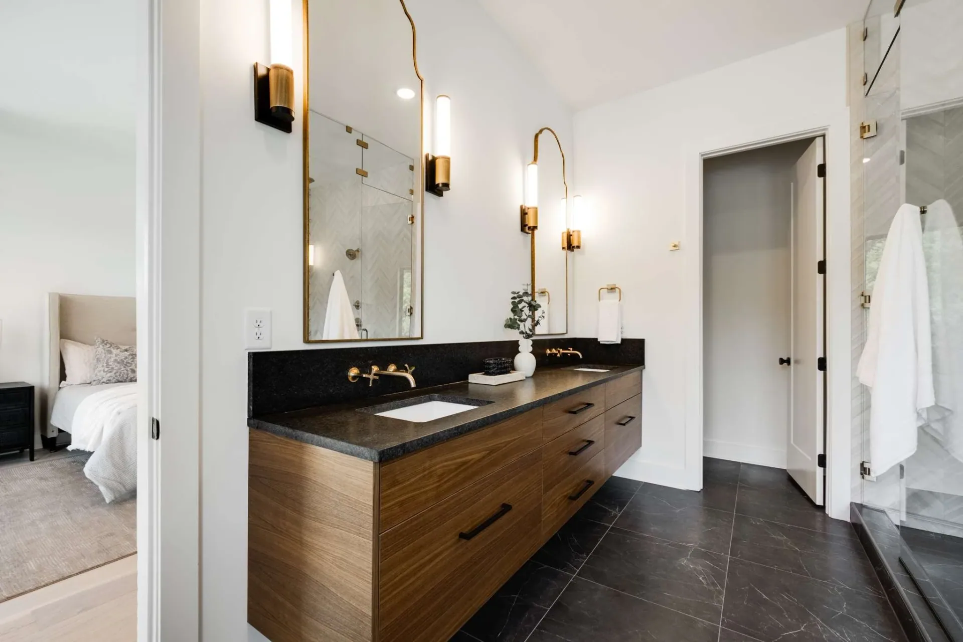 Floating wood bathroom vanity with black worktop