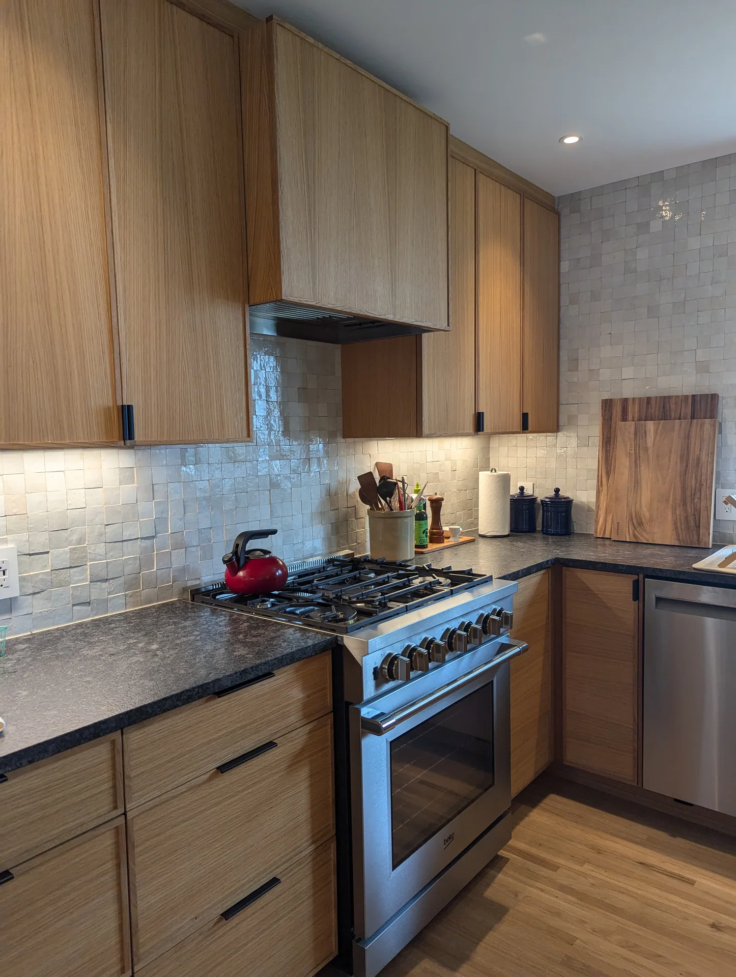 Mayfield Kitchen wood cabinets and hood surround above a stainless steel range