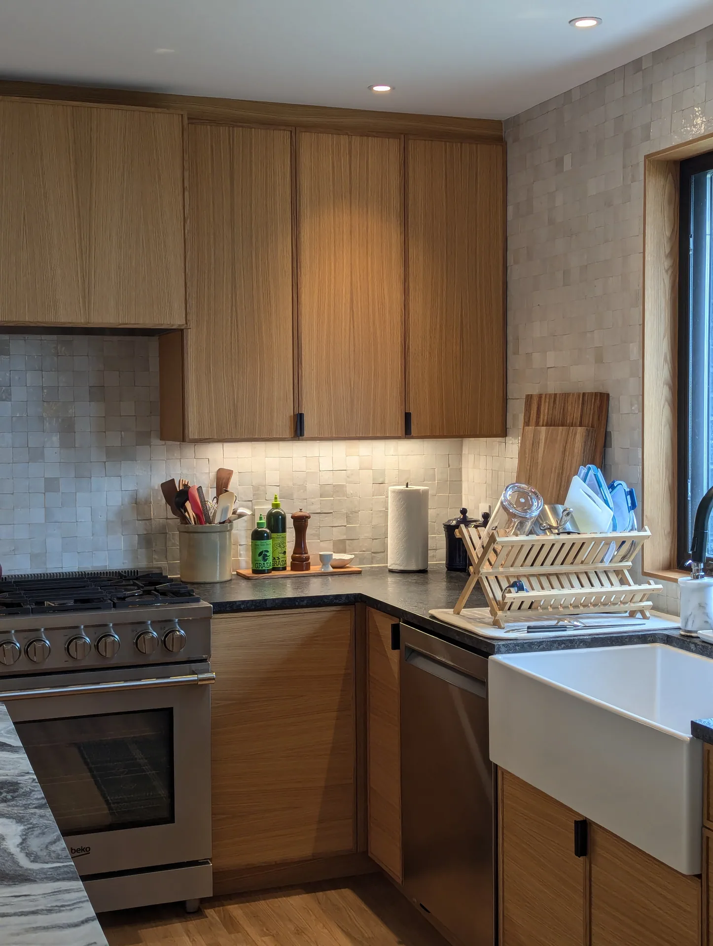 Corner wood cabinetry connecting the Mayfield Kitchen range and apron-front sink