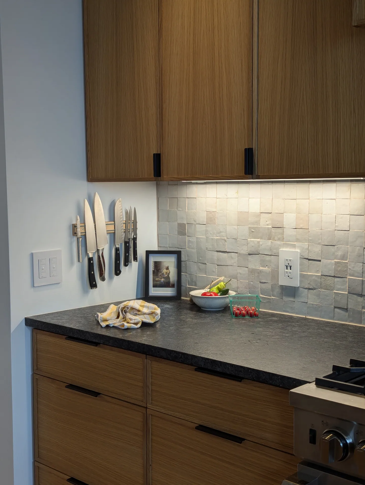 Mayfield Kitchen wood drawers and upper cabinets with black pulls and under-cabinet lighting