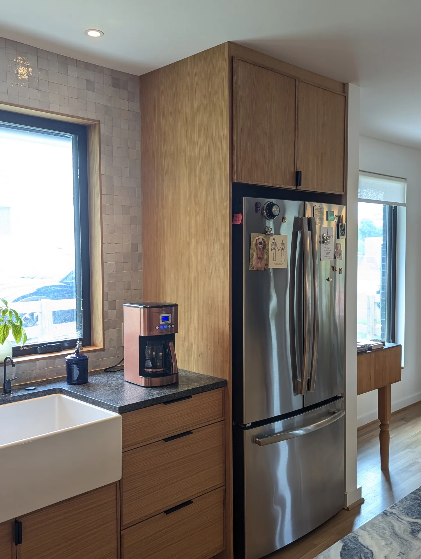 Wood refrigerator surround and adjacent drawer cabinetry in the Mayfield Kitchen