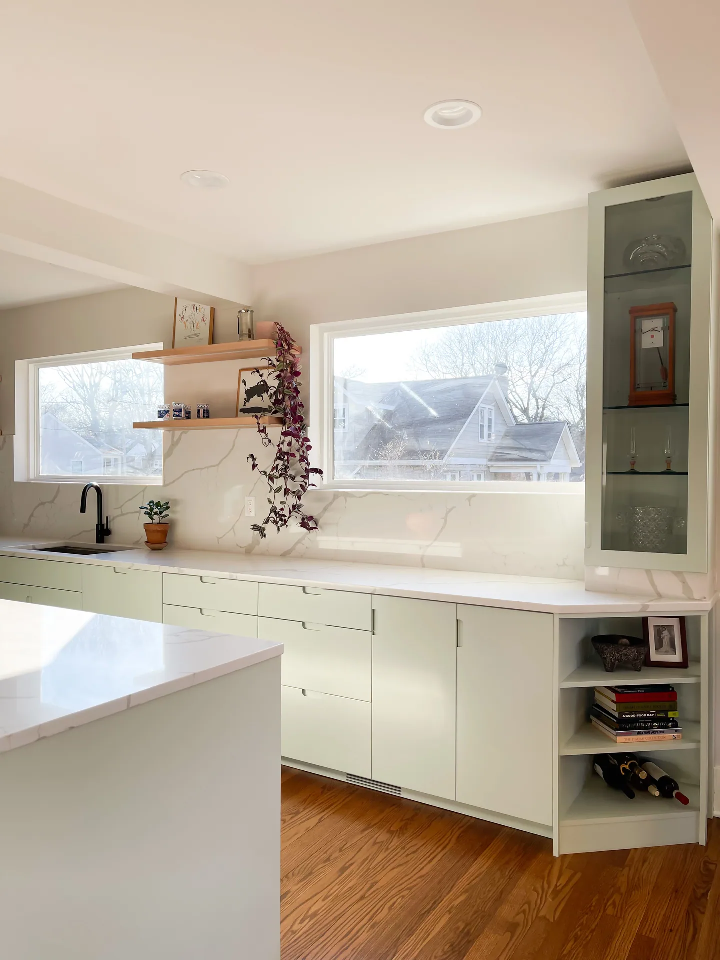 Glazed display cabinet and open corner shelves beside the Morton sink wall