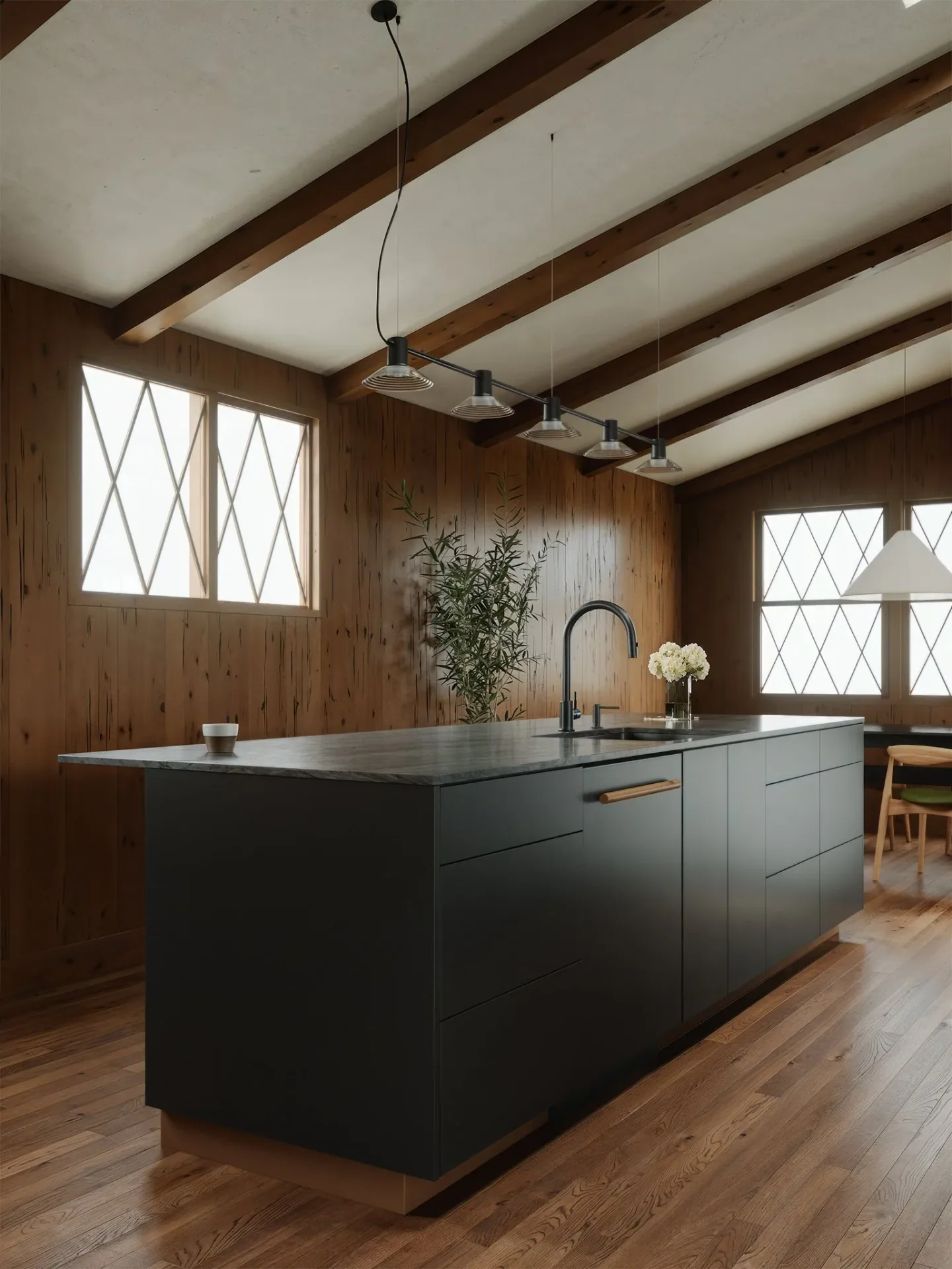Dark custom kitchen island and cabinetry in the wood-lined Vanoke interior