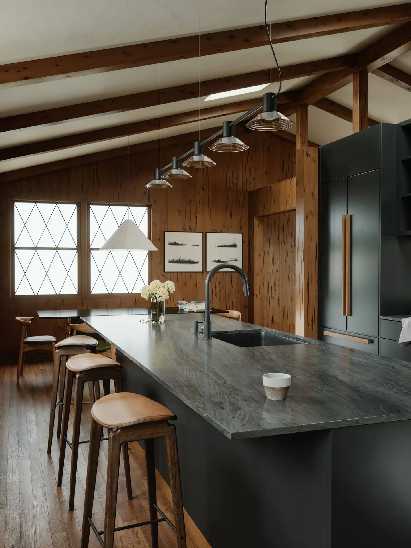 Dark Vanoke kitchen cabinetry seen from the dining area